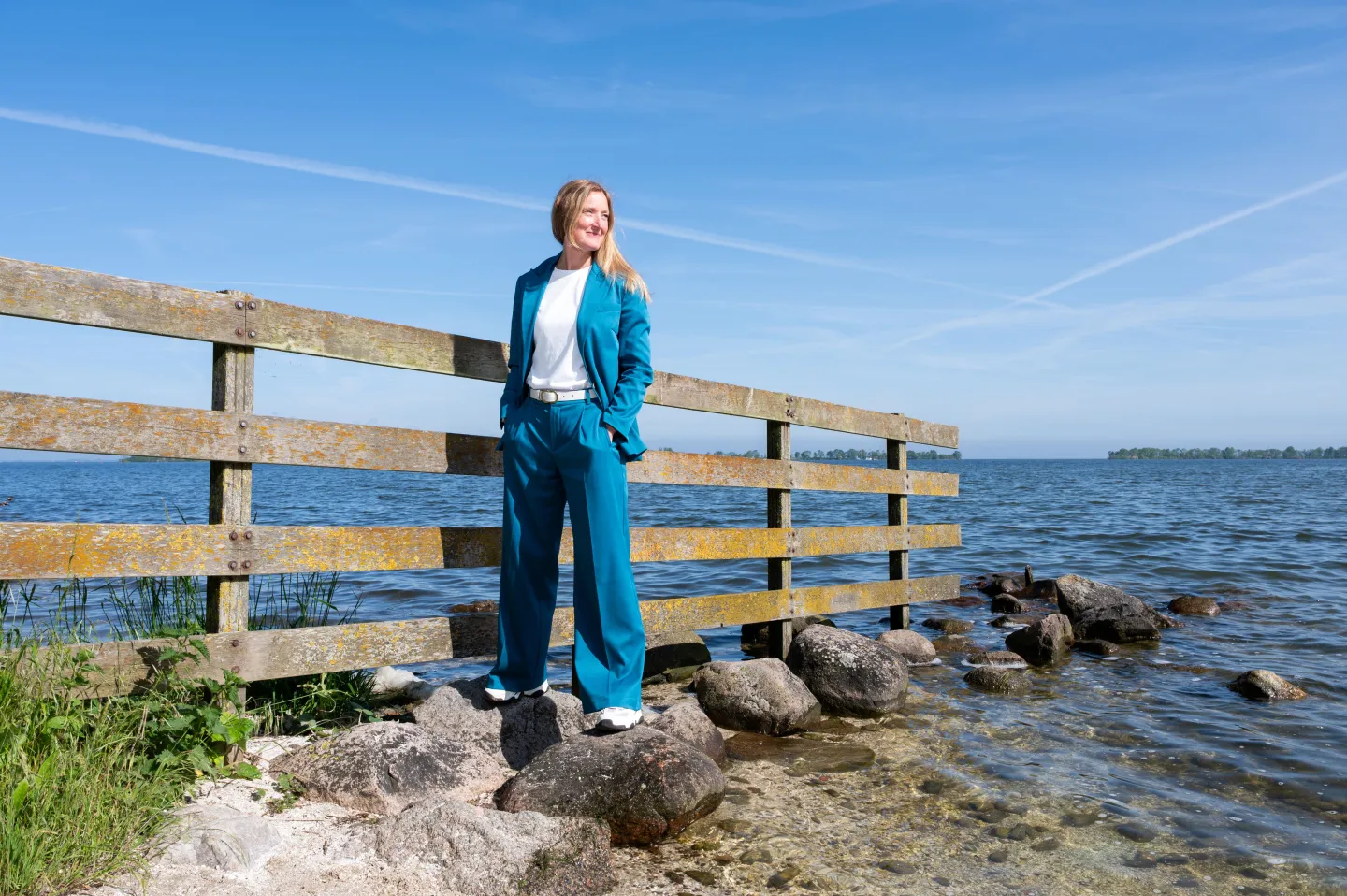 Maaike Romijn is standing on a row of stones jutting out into the water